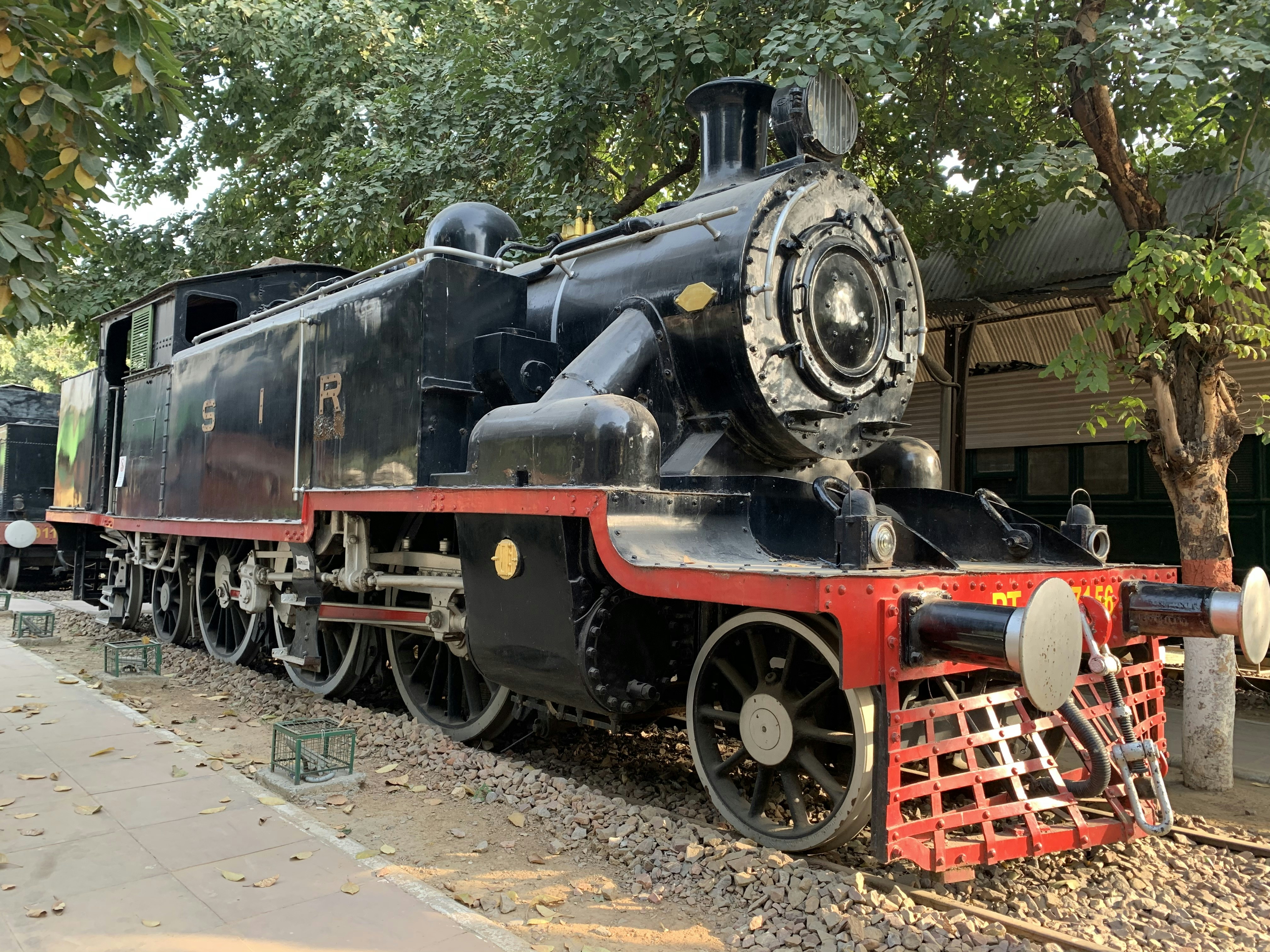 Classic 4-4-2 steam locomotive on open track, golden hour light, dramatic sky