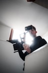 A person filming a video with a professional camera in a bright room