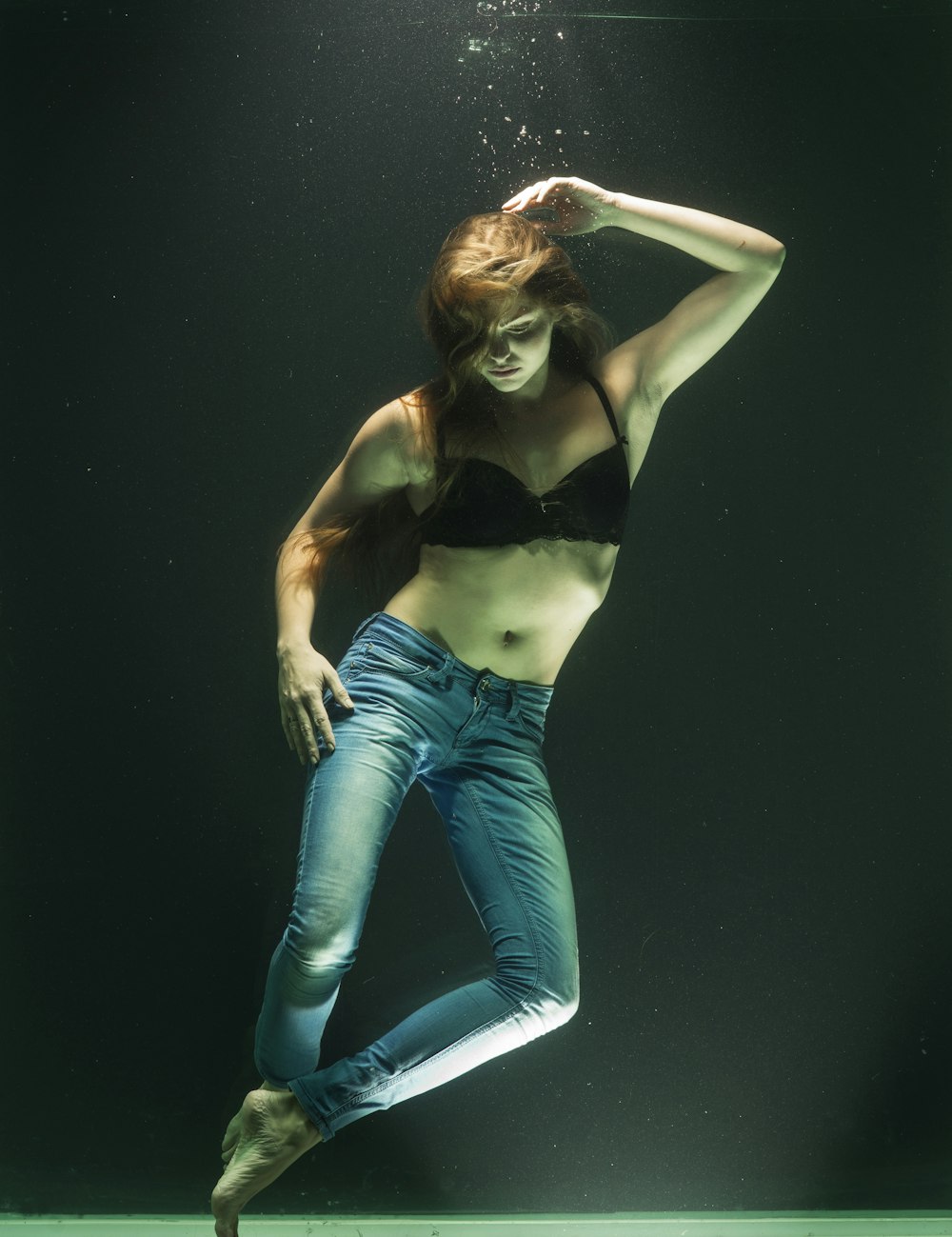 woman in black brassiere and blue denim jeans