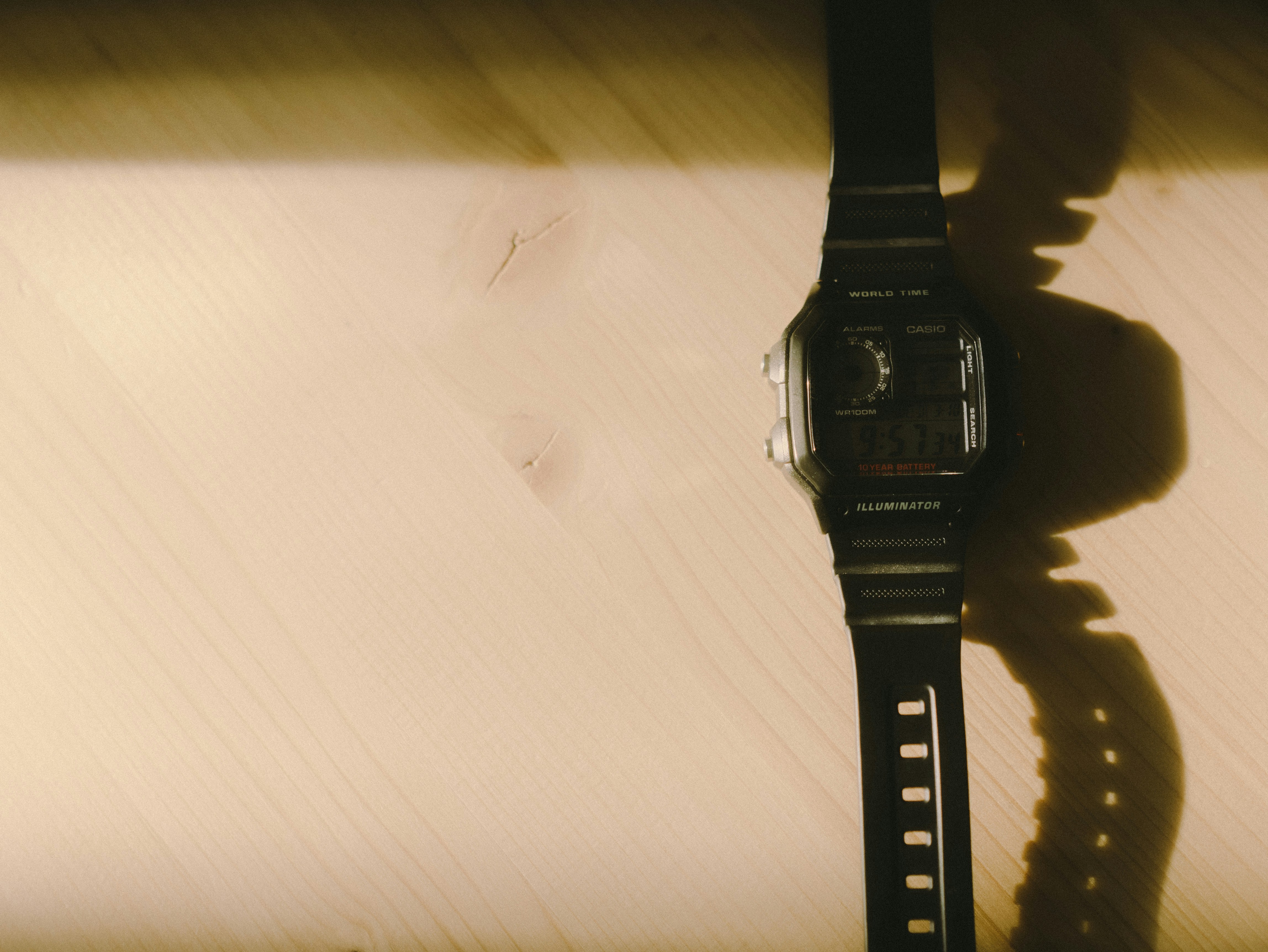 black digital watch on white textile