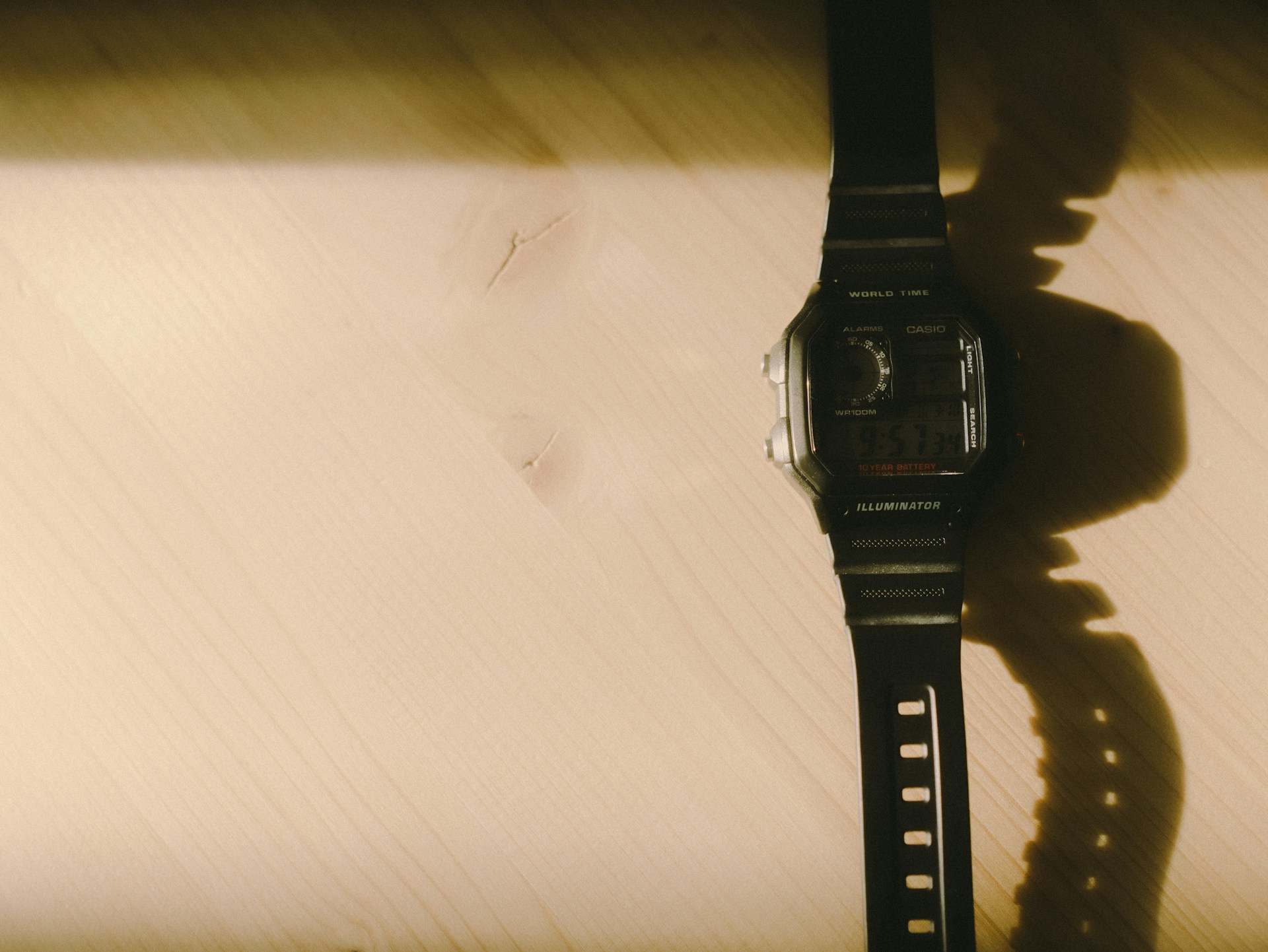 black digital watch on white textile