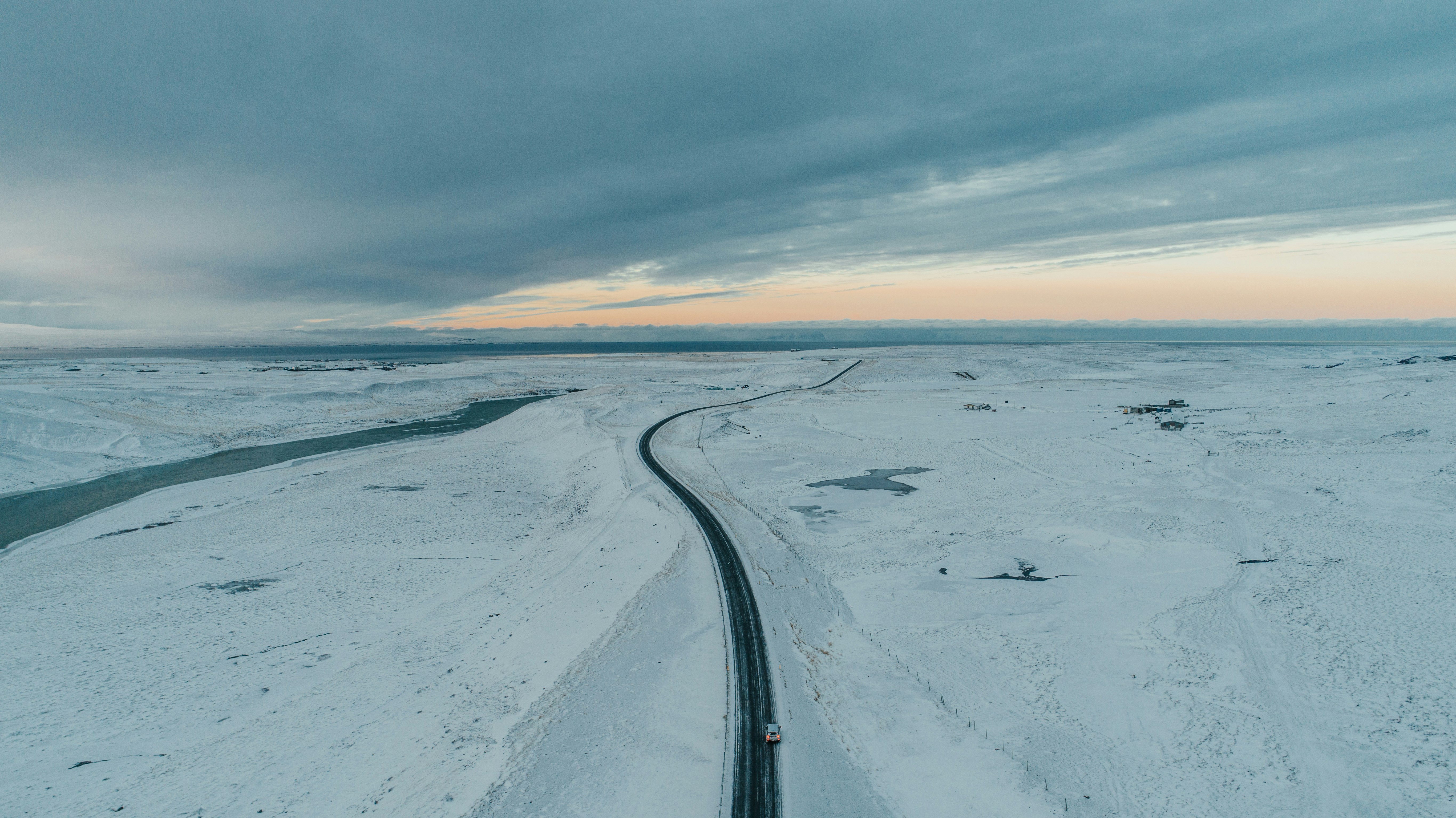 snow covered road under blue sky during daytime