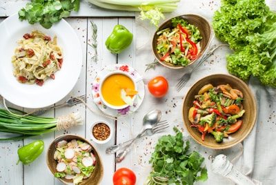 A vibrant assortment of fresh vegetables and herbs on a wooden table.