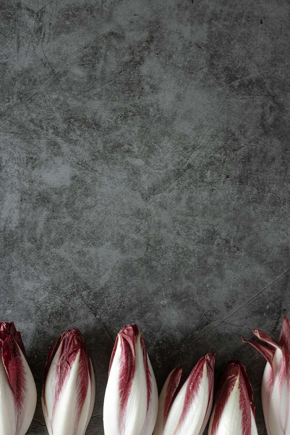 red and white textile on gray concrete floor