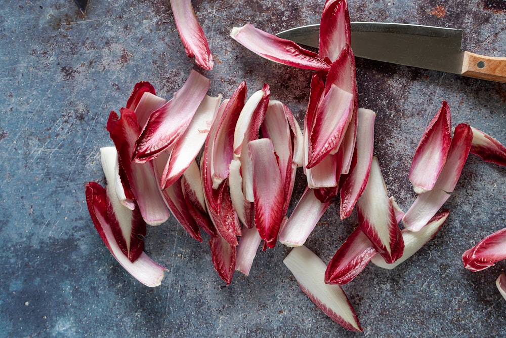 red and white plastic flower petals on gray concrete floor