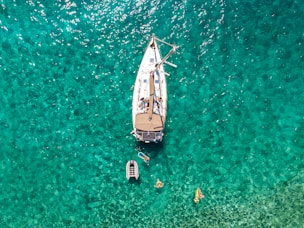 white and blue boat on body of water during daytime