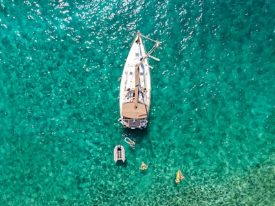 white and blue boat on body of water during daytime