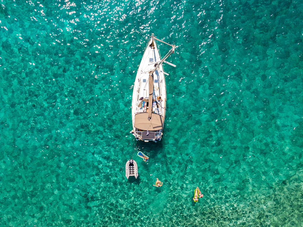 white and blue boat on body of water during daytime