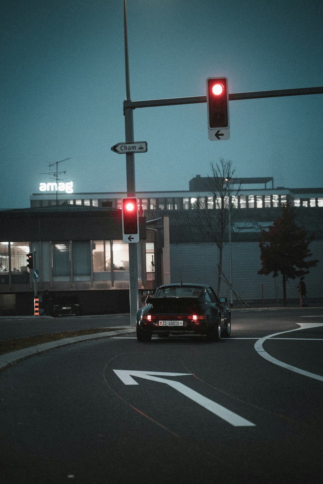 black car on road near traffic light during daytime