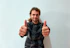 Smiling female customer giving thumbs up after plumbing service.