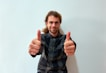 A smiling customer, Alex J., giving a thumbs up.