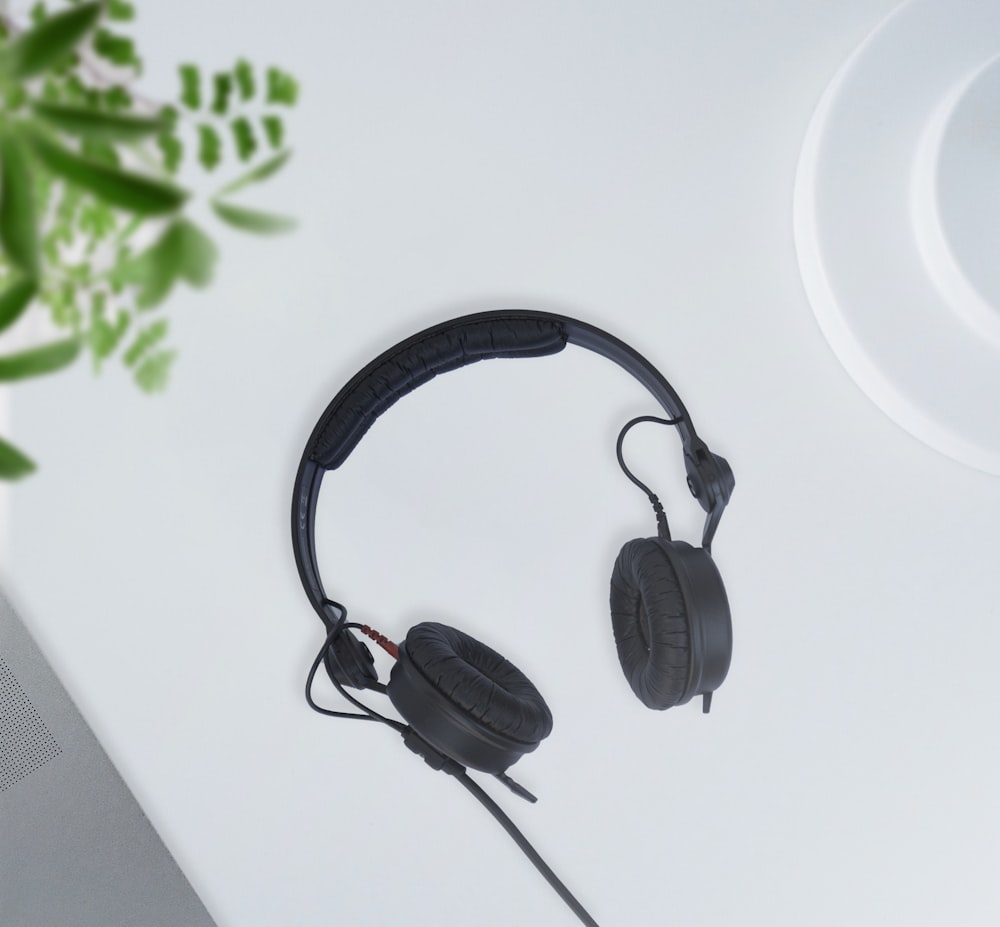 black corded headphones on white table