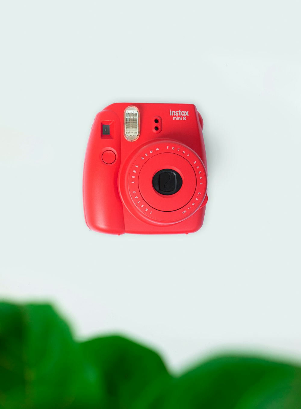 red nikon point and shoot camera