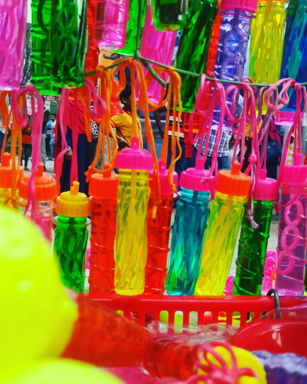 red plastic basket with assorted color plastic bottles