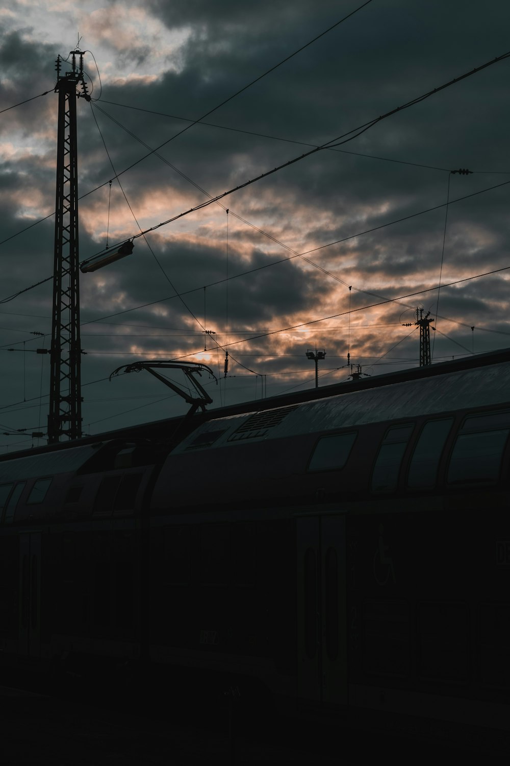 black train under white clouds during daytime