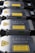A row of metallic laser modules with visible warning labels and engraved text. The modules are aligned neatly, showcasing their industrial design. The labels contain laser hazard warnings and technical specifications.