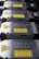 A row of metallic laser modules with visible warning labels and engraved text. The modules are aligned neatly, showcasing their industrial design. The labels contain laser hazard warnings and technical specifications.