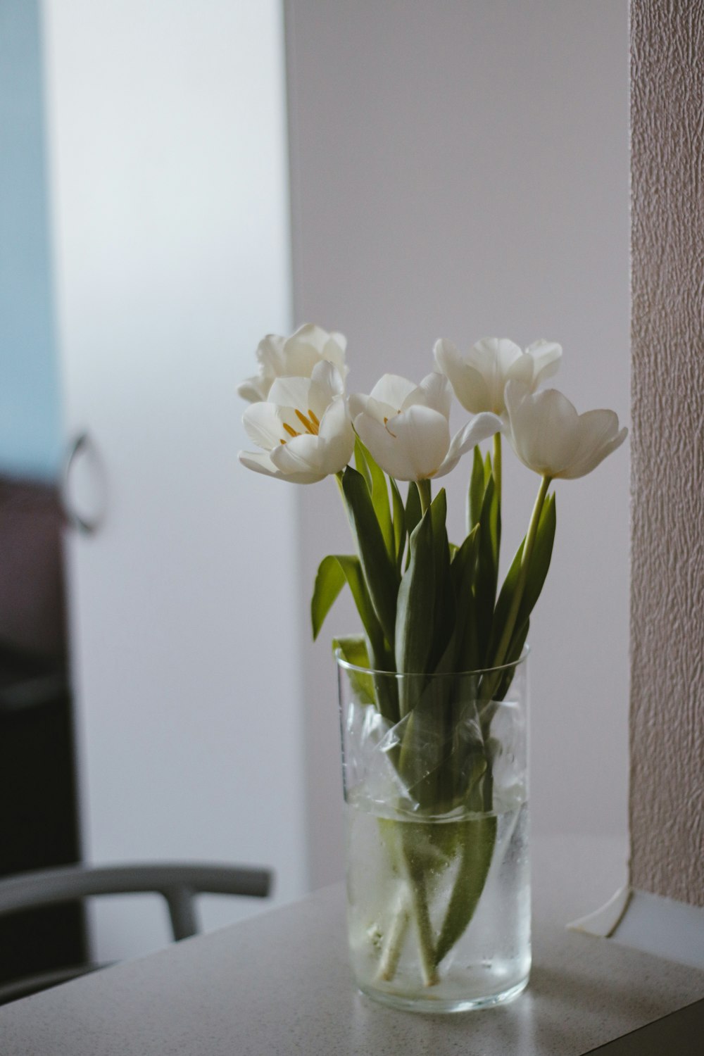 white flowers in clear glass vase