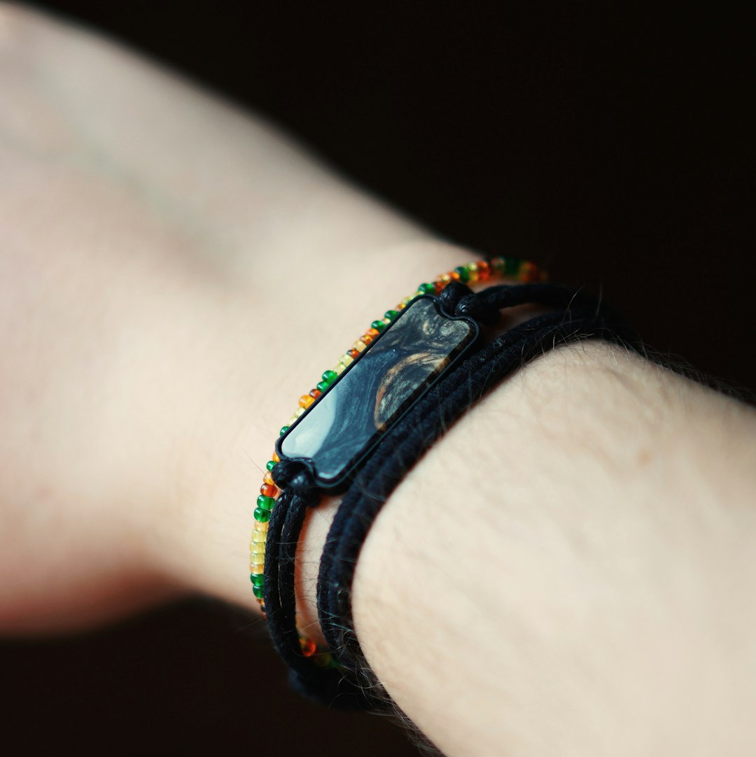 person wearing blue and black bracelet