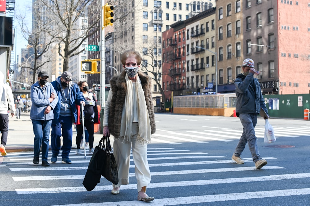 man in black jacket walking on pedestrian lane during daytime