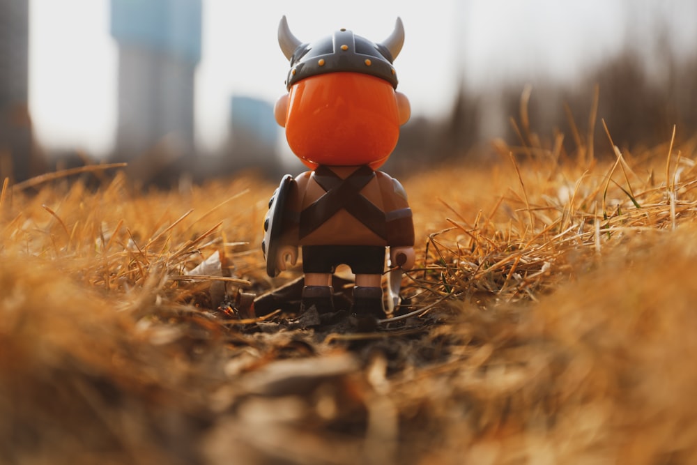 red and black plastic toy on brown grass