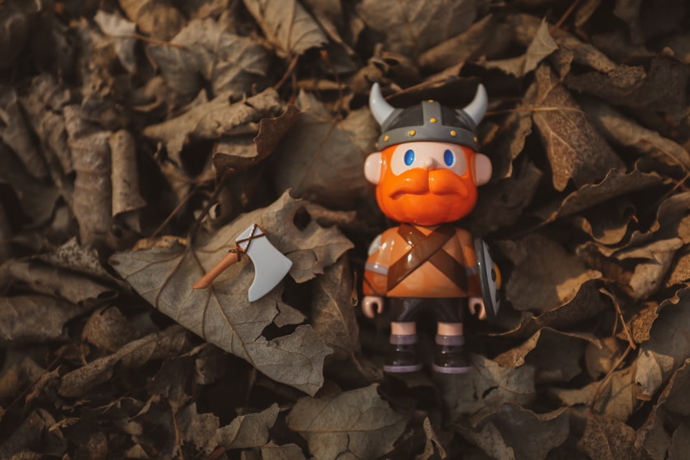 mickey mouse figurine on dried leaves