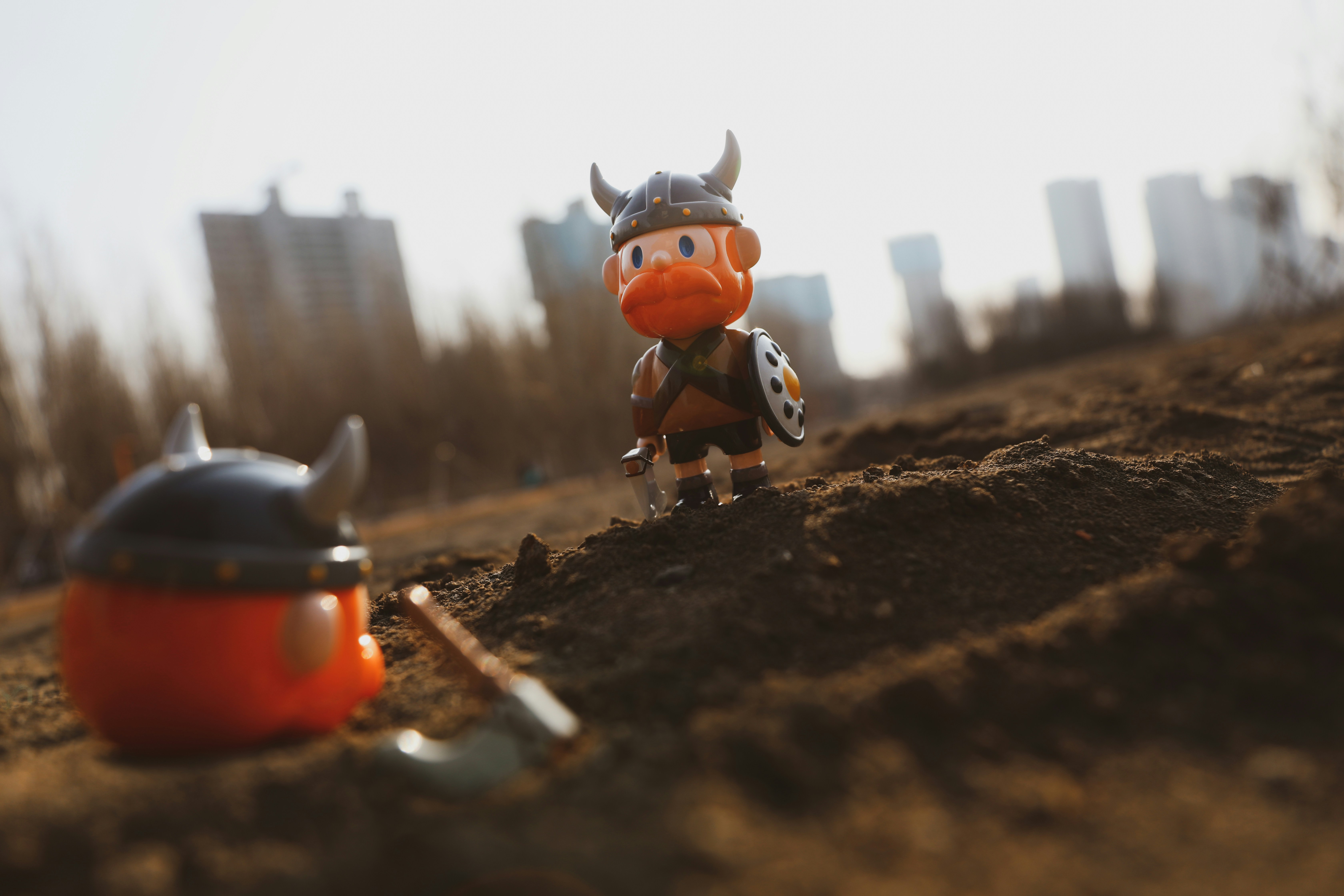 red and white plastic toy on brown soil during daytime