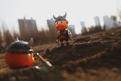 red and white plastic toy on brown soil during daytime
