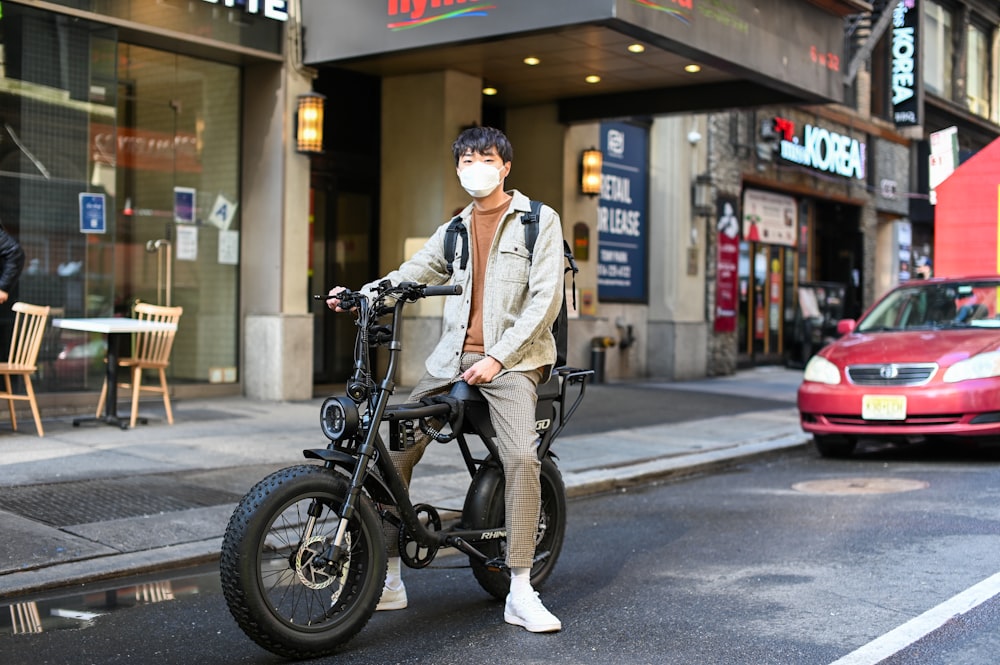 man in white dress shirt and black pants riding on black motorcycle during daytime