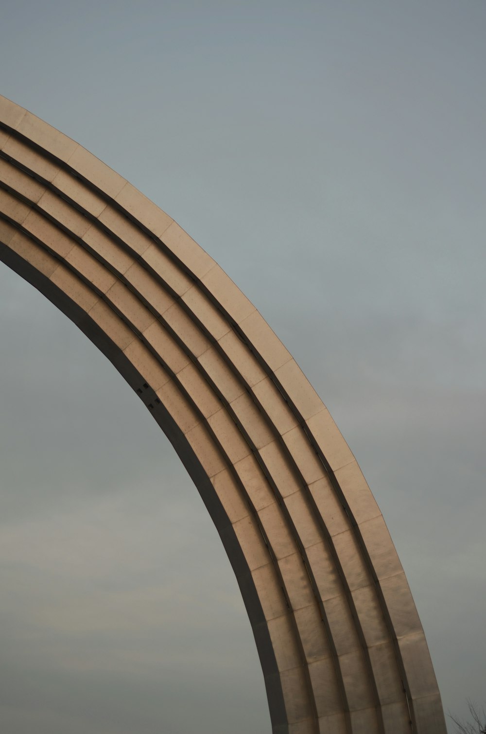 a large arch with a clock on top of it