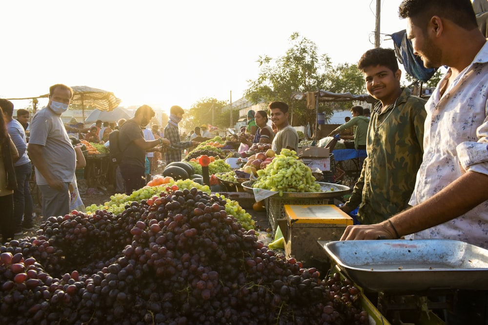 people standing near fruit stand during daytime