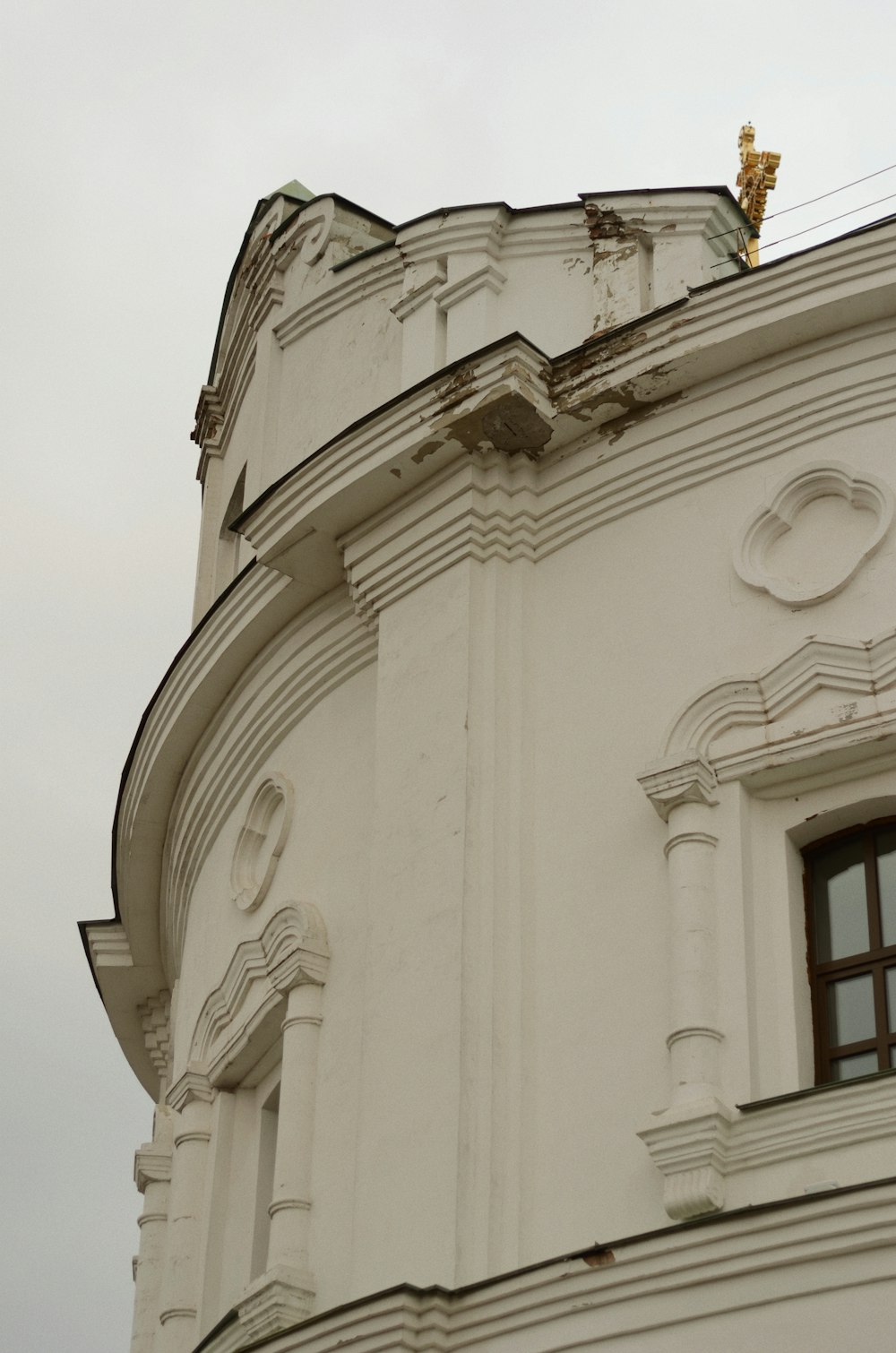 a large white building with a clock on it's side