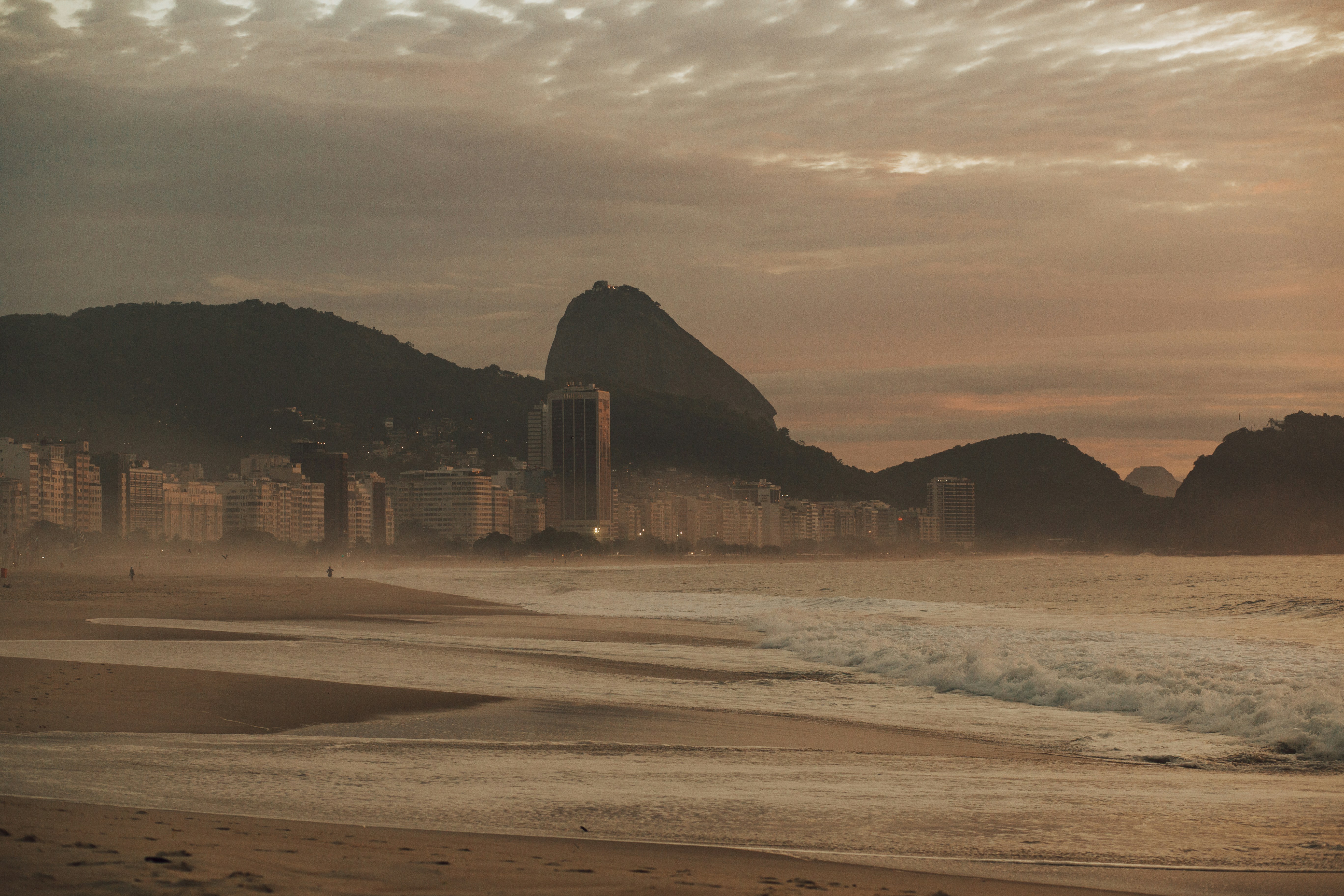 brown sand near body of water during daytime