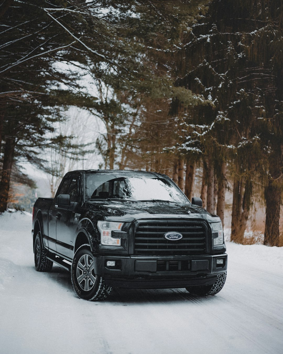 black suv on snow covered ground during daytime