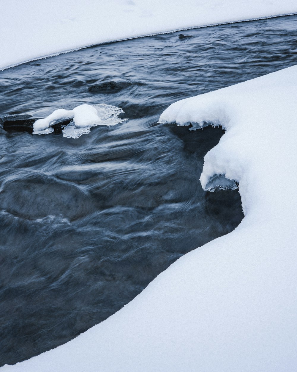 white ice on body of water