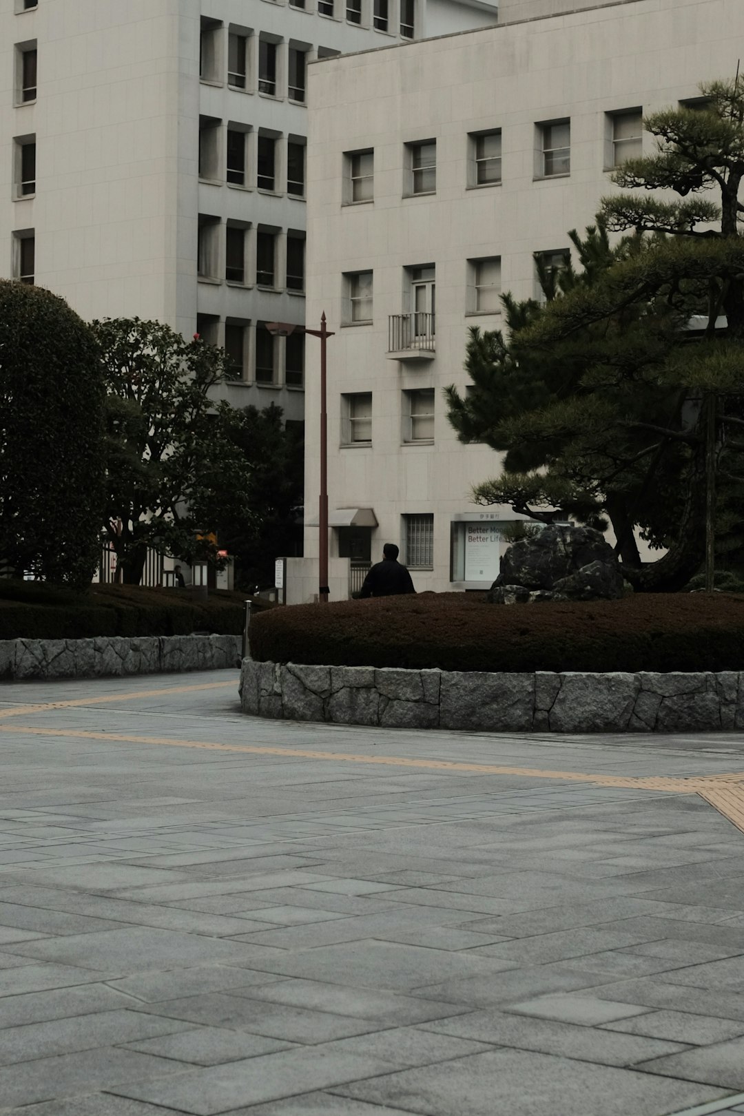 white concrete building near green trees during daytime