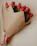 Close-up of a vibrant bouquet of roses and tulips wrapped in rustic paper.