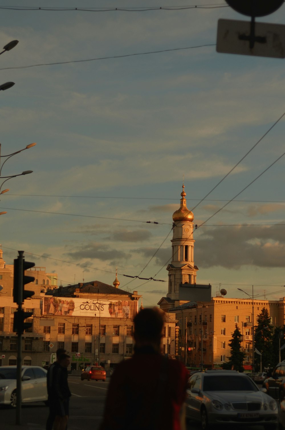 a view of a city street with a church in the background