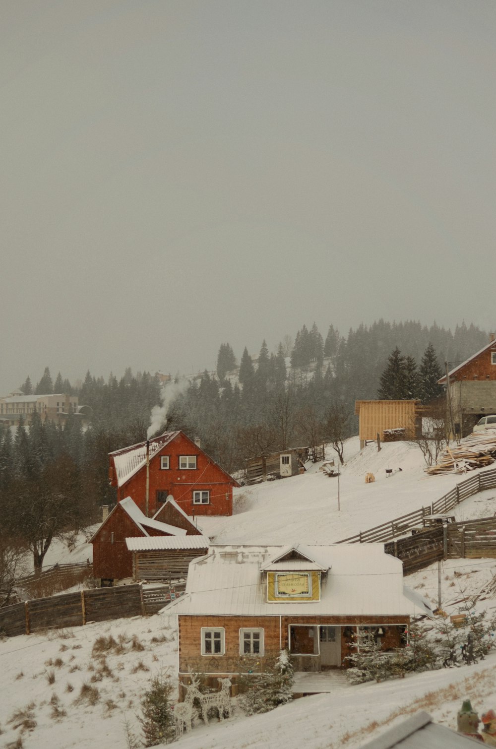 a snow covered hillside with houses and trees