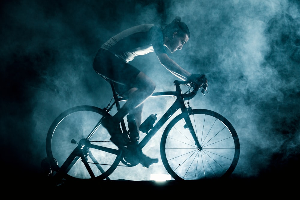 man riding on black bicycle