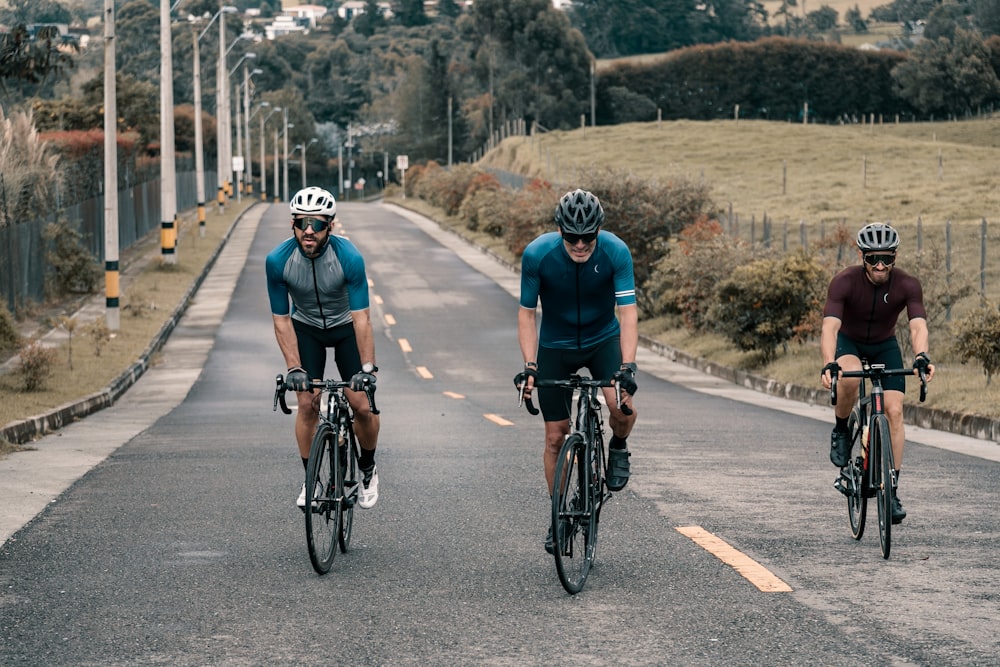 man in black and white bicycle helmet riding on bicycle on road during daytime