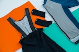 black and gray textile on orange and blue textile
