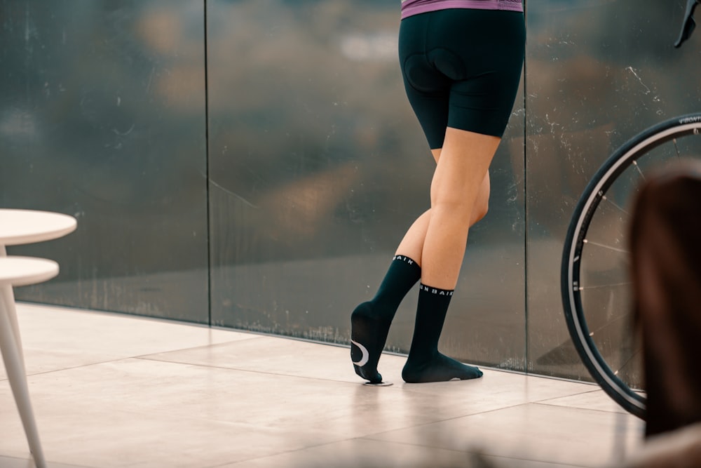 woman in black leggings and black boots