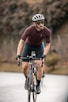 man in red long sleeve shirt riding on black bicycle