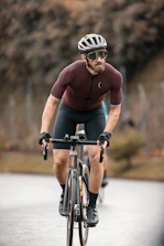 A para triathlete cycling fiercely with determination on a sunny day.