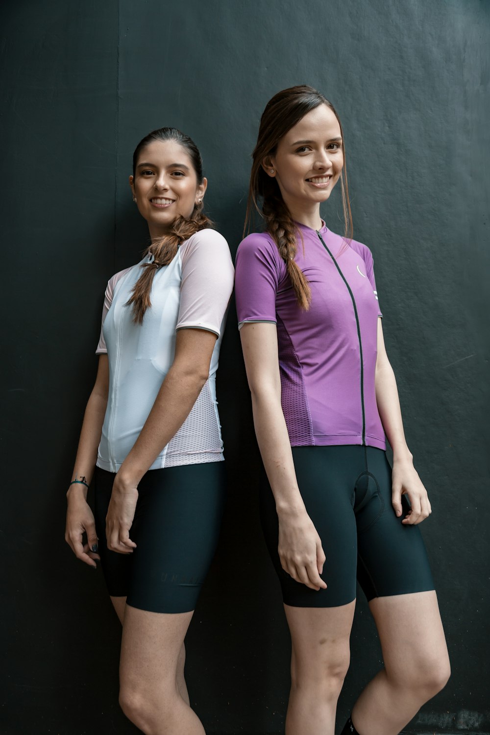 woman in pink shirt beside woman in white polo shirt