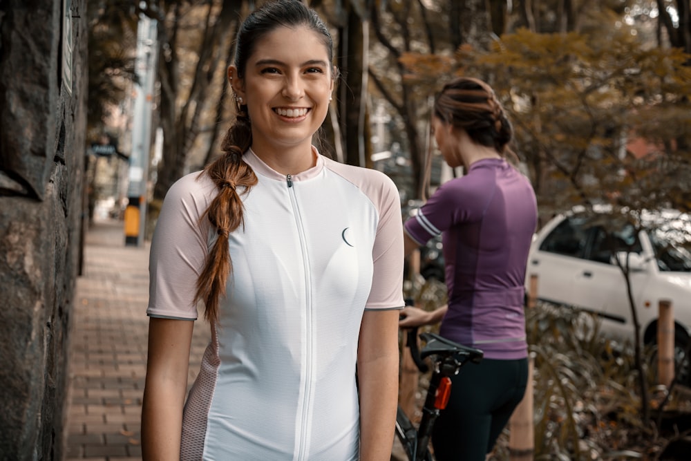 woman in white crew neck t-shirt and blue denim jeans riding on bicycle