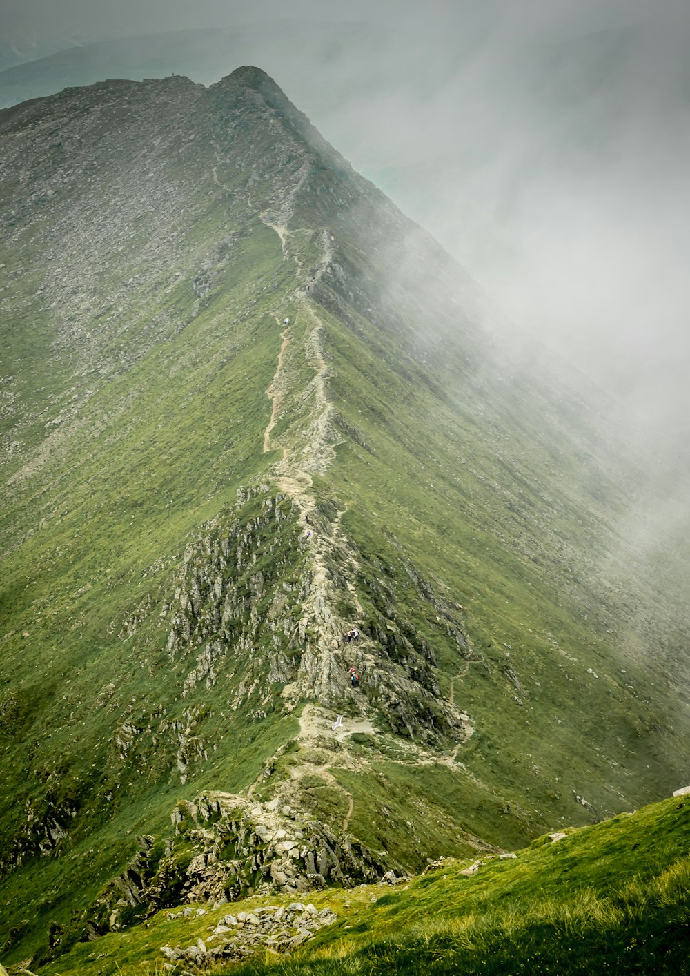 green mountain under white clouds during daytime