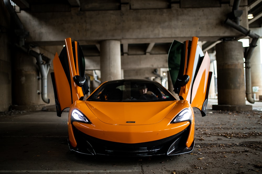 orange lamborghini aventador parked on street during daytime