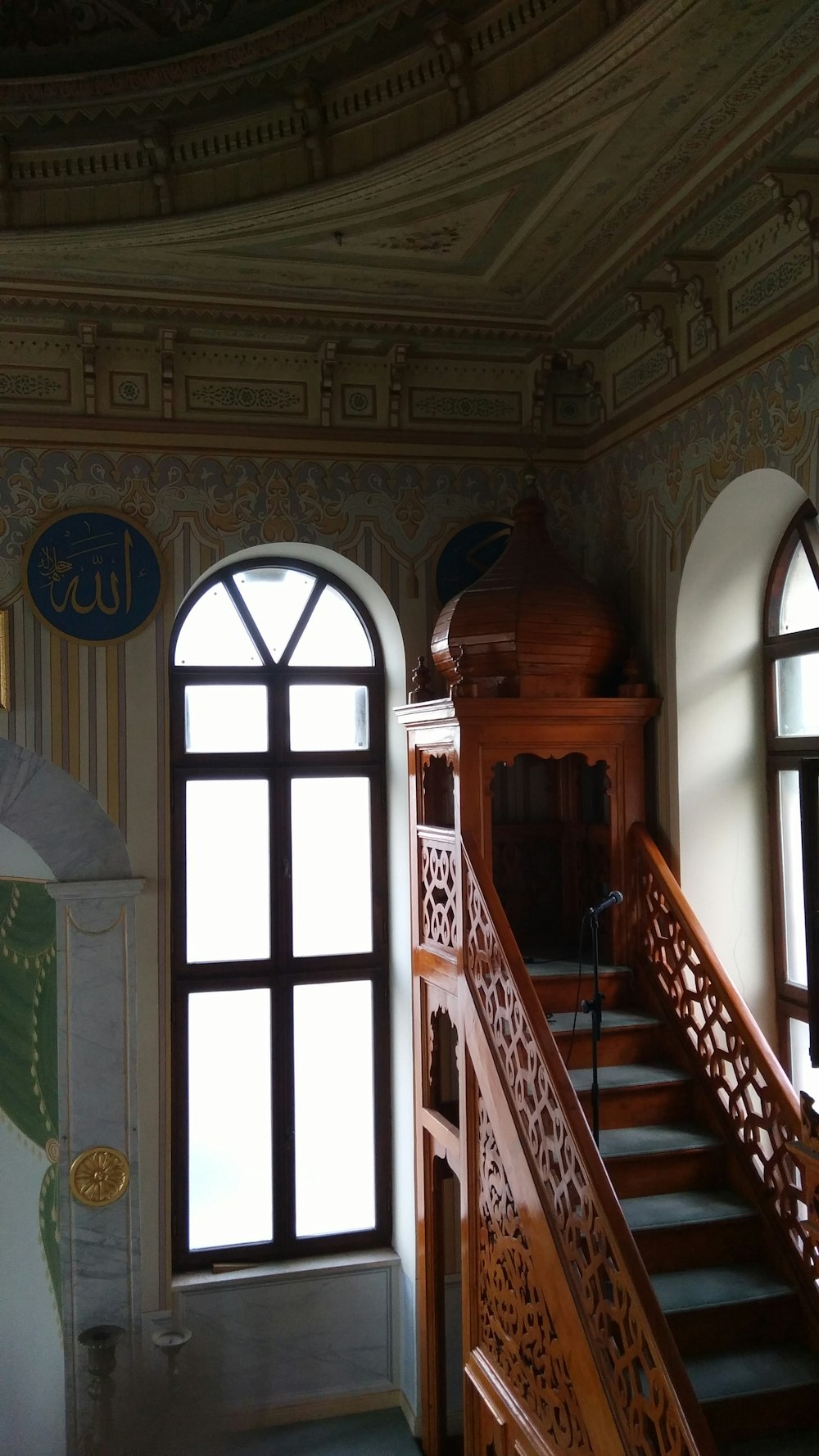 brown wooden door near green window curtain